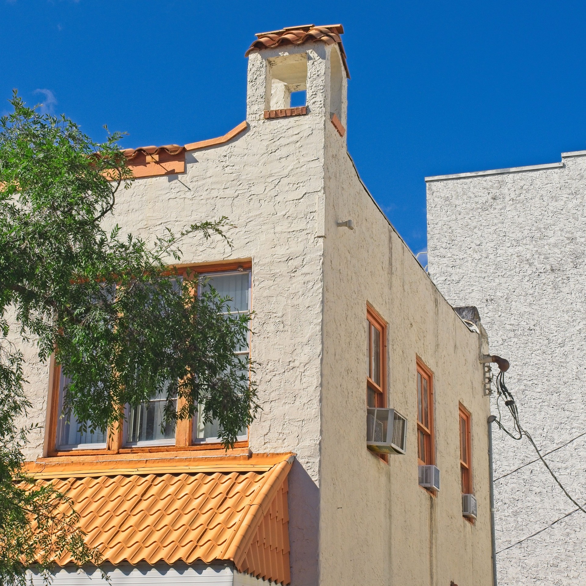 Corner of stucco and tiled roof bakery shop in downtown Cocoa Village Florida