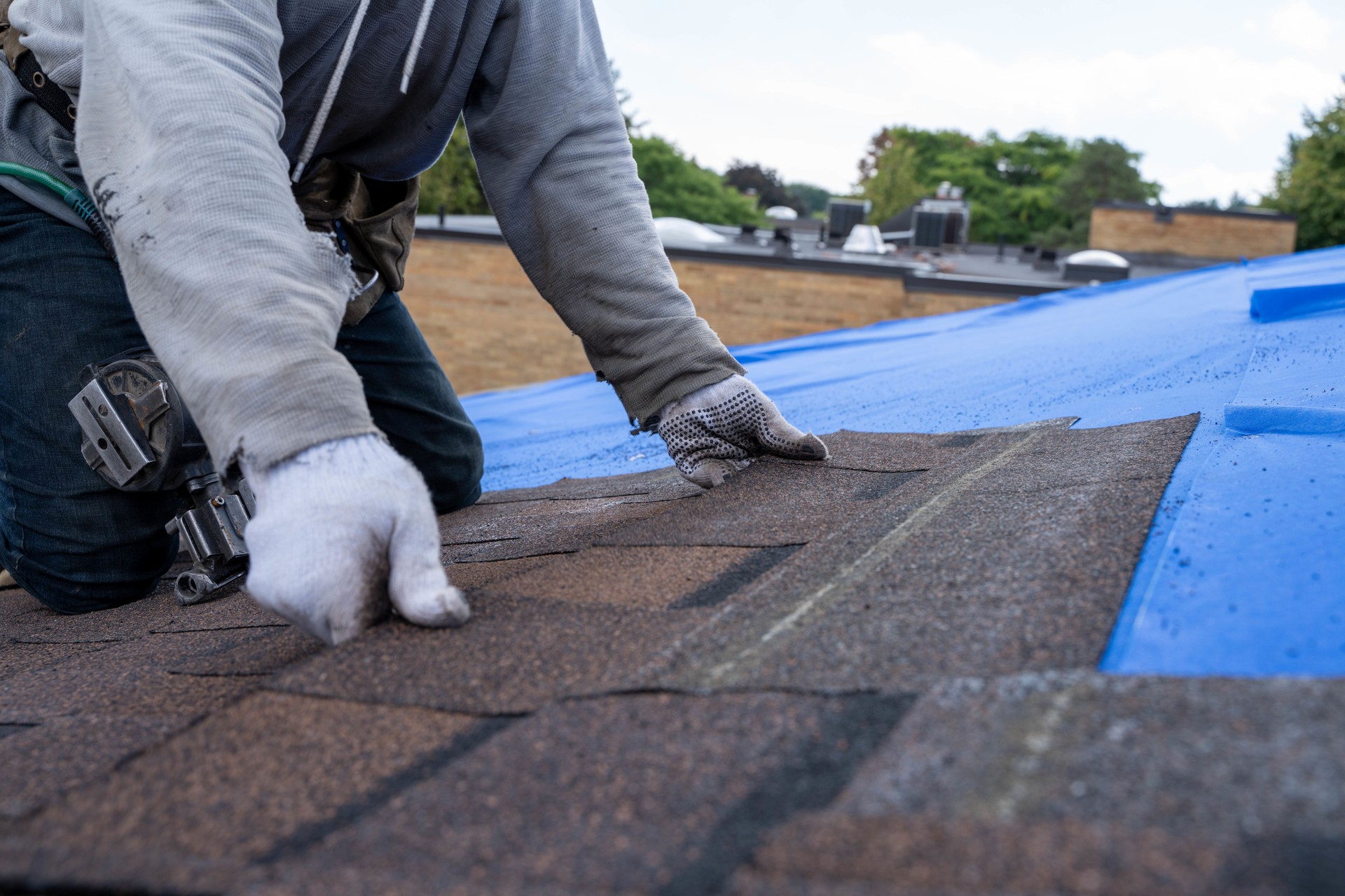 Roofers installing new roof on house